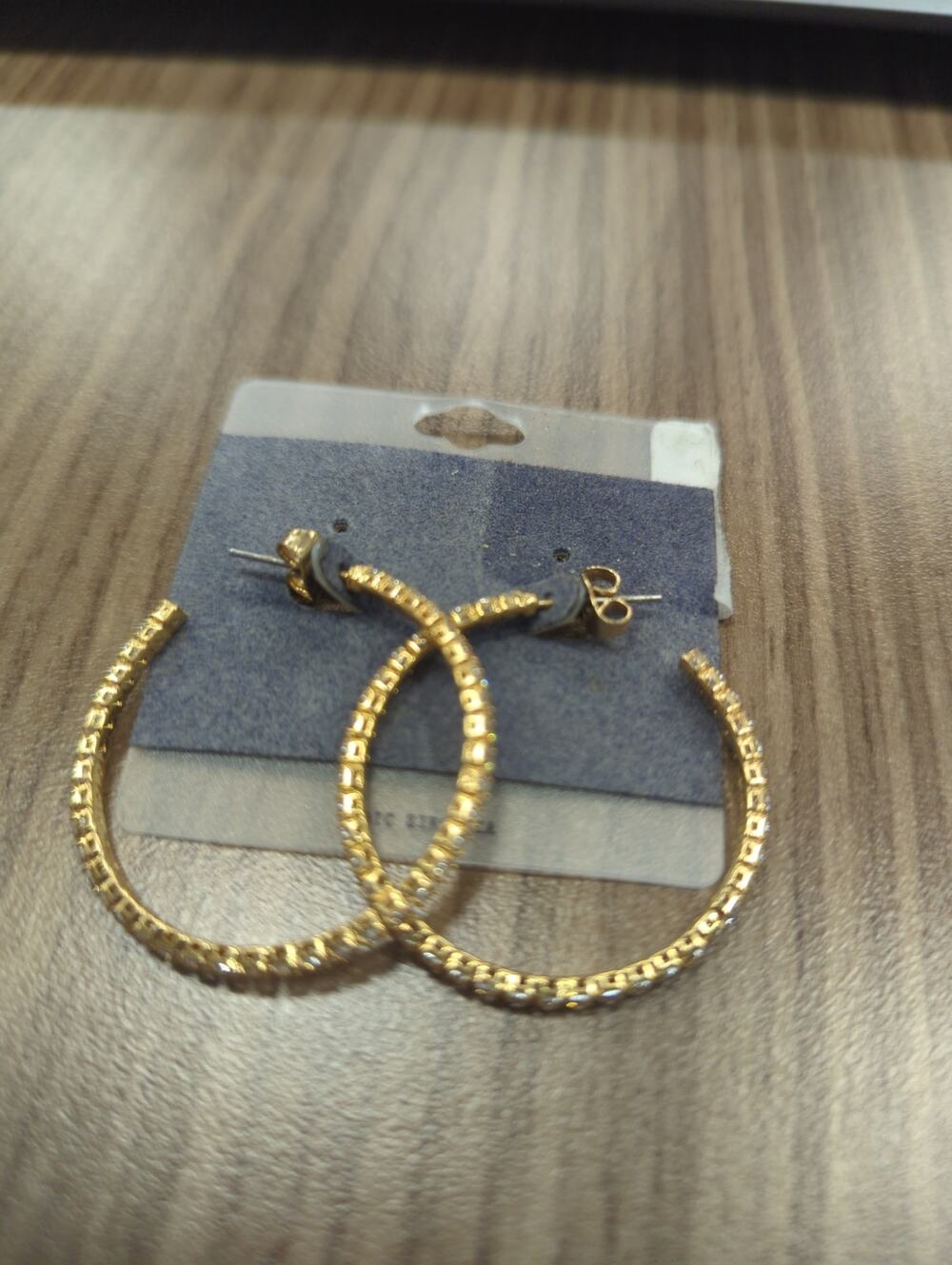 Gold hoop earrings with white rhinestones